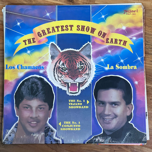 Vinyl album cover with images of two people and a tiger, featuring 'Los Chamanes' and 'The Greatest Show on Earth'.